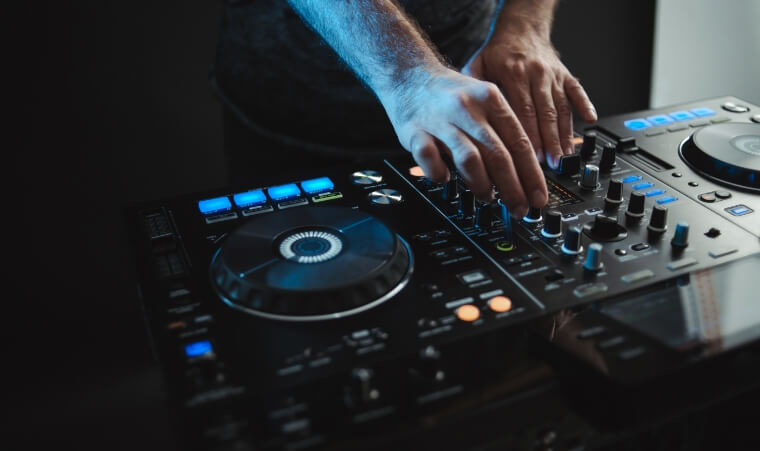 Artist performing on a DJ controller